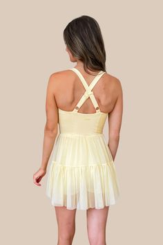 The cutest activewear dress that's fashionable and functional for everything from running errands, to dance, pickleball, running, tennis and more! The Popflex Corset Pirouette Dress in Buttercream yellow features incredibly soft fabric, a scoop neckline, an outer tulle skirt with shorts underneath featuring side pockets. This item is excluded from some discounts. *Authorized Popflex retailer* Becca is 5'5", Bust 33", Waist 25", Hips 33" wearing a size XX-Small.