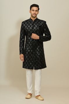 Black sherwani with all over Mughal ogee pattern, thread and sequin embroidery. Paired with a white churidar. - Aza Fashions Formal Sherwani With Mirror Work, Transitional Black Sherwani With Cutdana, Black Sherwani With Chikankari Embroidery, Formal Sherwani With Mirror Work For Diwali, Black Chikankari Embroidered Sherwani, Black Chikankari Embroidery Sherwani, Formal Kurta With Mirror Work For Diwali, Formal Mirror Work Kurta For Diwali, Black Sherwani With Mirror Work