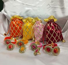 several different colored bags and rings on a white surface