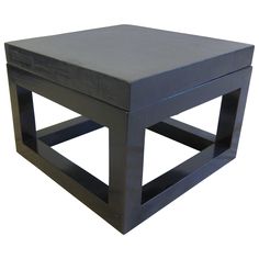 a black square table sitting on top of a white floor