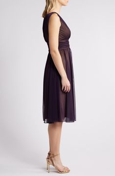 A gathered chiffon overlay adds contemporary dimension to a party-ready sleeveless dress with a fitted, surplice bodice balanced by a perfectly flared skirt. 43" length Hidden back-zip closure Surplice V-neck Sleeveless Lined 100% polyester Machine wash, tumble dry Imported Sleeveless Pre-draped Dress With Ruched Back, Pre-draped Ruched Bridesmaid Dress, Formal Sleeveless Dress With Ruched Bodice, Sheer Sleeveless Silk Chiffon Dress, Knee-length Chiffon Sleeveless Party Dress, Knee-length Chiffon Midi Dress With Ruched Detail, Knee-length Ruched Chiffon Midi Dress, Fitted Silk Chiffon Dress For Wedding Guest, Ruched Chiffon Midi Dress Knee-length