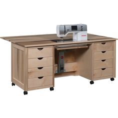 a sewing machine sitting on top of a wooden table next to drawers and cabinets with drawers underneath it