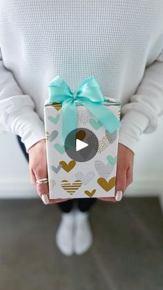 a person holding a present with a bow on it