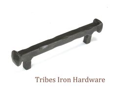 an iron handle on a white background with the words tribe iron hardware written below it