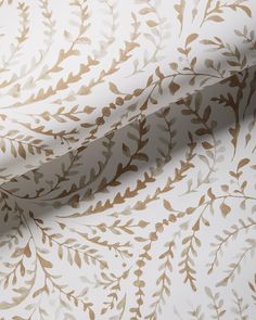 a white and gold wallpaper with leaves on it