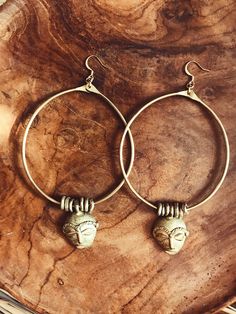 "Handmade brass hoops featuring African masks and textured brass beads that were made by African artisans. *The mask on each pair of hoops will vary is style and size. No 2 are alike. DETAILS: Metal: Brass Size:3\" Gold plated ear wire Ships with polishing cloth *The mask and beads have been left un-polished and May feature some patina. Return to shop: Afrohemien.etsy.com Like and Follow Afrohemien for updates, sales, coupons and surprise giveaways Instagram/Blog: instagram.com/Afrohemien Tumblr Festive Brass Hoop Earrings With Ear Wire, Festive Handmade Brass Hoop Earrings, Traditional Adjustable Brass Hoop Earrings, Festival Bronze Brass Hoop Earrings, Spiritual Gold Hoop Earrings In Brass, Bohemian Hammered Hoop Earrings, Oxidized Brass Hoop Earrings, Brass Hoop Earrings With Oxidized Finish, Bohemian Bronze Hoop Earrings In Brass