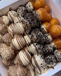 a box filled with lots of different types of donuts on top of each other