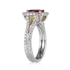 Your future wife will fall madly and more deeply in love with you when you present her this magnificent ring. The beauty at the center is a 1.66ct ruby GIA graded purplish-red. Its color is intense and gorgeous and contrasts well with the halo of colorless diamonds. Coming down from the top of the ring is a split shank also adorned with diamonds. Luxury Ruby Ring With Halo, Luxury Cushion Cut Ruby Ring With Halo Setting, Luxury Ruby Halo Wedding Ring, Luxury Ruby Halo Diamond Ring, Luxury Ruby Halo Setting Wedding Ring, Luxury Ruby Wedding Ring With Halo Setting, Luxury Ruby Diamond Ring With Halo, Luxury Ruby Ring With Diamond Halo, Dazzling Ruby Ring With Vvs Clarity