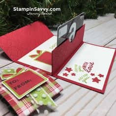 an open christmas card on a wooden table