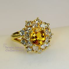 Thank you for coming in! This Vintage Ring has a strong striking yellow sapphire as its center piece. The sapphire is bezel set into a fancy setting with 8 heart and 8 round diamonds totaling 1.8 carats! Ring Size: 7.75 Total Weight: 9.58 grams Precious Metal: 18k solid gold Precious stones: -Yellow Sapphire: 2.92 carats, 9mm x 7.3mm -White Round Diamonds: 1.8 ct Hallmark: A18K Luxury Multi-stone Yellow Gemstones, Luxury Yellow Multi-stone Gemstones, Luxury Multi-stone Yellow Diamond Ring, Fine Yellow Oval Sapphire Ring, Luxury Yellow Oval Sapphire Ring, Yellow Multi-stone Round Gemstones, Yellow Gold Cluster Sapphire Ring With Center Stone, Yellow Gold Sapphire Cluster Ring With Center Stone, Gold Oval Yellow Sapphire Ring