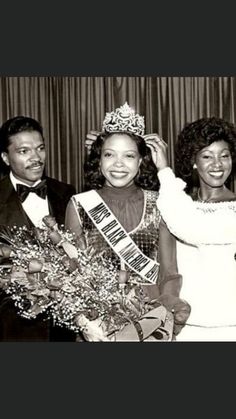 an old black and white photo of three women in formal wear posing for the camera