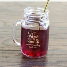 a mason jar filled with red liquid and a gold straw sticking out of the top