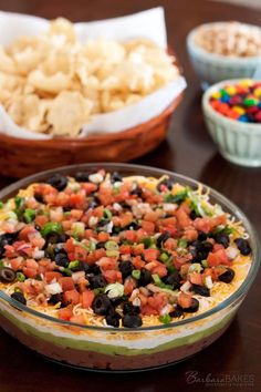 the mexican dip is ready to be served with tortilla chips and sour kraut