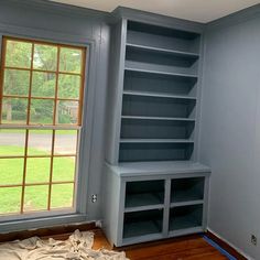 the room is empty and ready for paint to be painted in blue, with shelves on either side