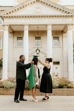 a man and woman standing in front of a building