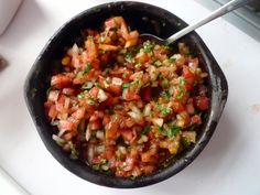 a bowl filled with lots of food on top of a table