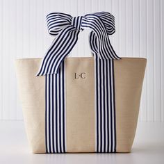 With soft ribbon detailing and a signature bow handle design, this beautifully woven natural straw tote is perfect for spring and summer days, girls getaways, bachelorette weekends and more. Make it yours - or theirs - with a custom embroidered monogram. Match the ribbon bow with a coordinated color or opt for neutral embroidery for a soft tonal look.    14"w x 5"d x 13.5"h  Woven from paper straw with polyester webbing ribbon detailing.  Linen cotton blend interior lining.  Wipe clean with damp Neutral Embroidery, Monogramed Gifts, Straw Beach Bag, Bow Bag, Monogram Tote Bags, Mark And Graham, Embroidered Monogram, Monogram Tote, Personalized Tote Bags