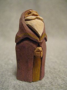 a small wooden toy with a piece of wood in the shape of a woman's head