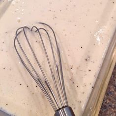 a metal whisk in a pan filled with batter