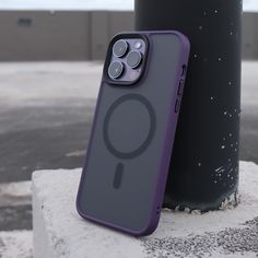 an iphone case sitting on top of a cement block next to a pole and street light