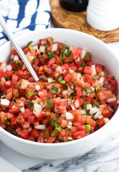 a white bowl filled with chopped tomatoes and onions