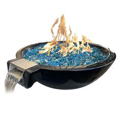 an outdoor fire pit with blue rocks and flames