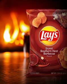 lay's sweet southern heat barbecue potato chips are shown in front of a fire