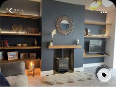 a living room filled with furniture and a flat screen tv mounted on a wall next to a fire place