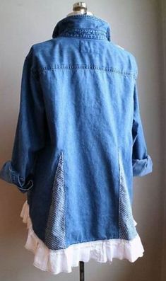 a blue jean jacket with white ruffles on the bottom, and an open collar