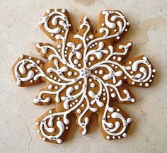 a cookie decorated with white icing on top of a table