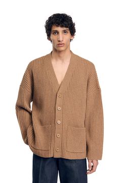 Oversized cardigan in chunky rib knit with full, long sleeves, V-neck, button fastening with tone-on-tone buttons and patch pockets. Sandro Men's oversized cardigan V-neck Long full sleeves 2 patch pockets The model is 6'1 tall and wears a size M Oversized Wool Casual Cardigan, Casual Oversized Wool Sweater Coat, Oversized Ribbed V-neck Outerwear, Oversized V-neck Ribbed Outerwear, Classic Wool Oversized Cardigan, Classic Oversized Wool Cardigan, Classic Oversized Ribbed Cardigan, Casual Wool Ribbed Cardigan, Oversized Ribbed Outerwear