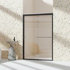 a white sink sitting next to a shower in a room with speckled wallpaper