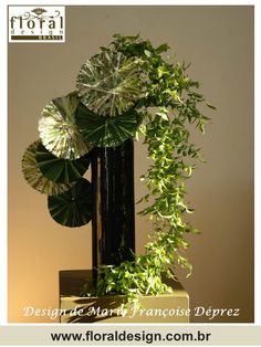 an arrangement of flowers and leaves in a vase