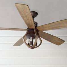 a ceiling fan with two wooden blades and a light fixture on it's side