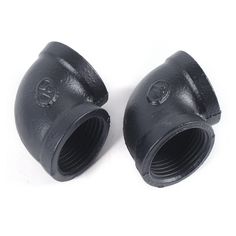 two black cast iron pipe fittings on a white background