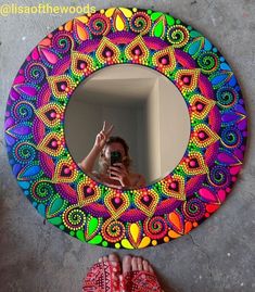 someone is taking a selfie in front of a colorful circular mirror with the words, i was happy with the center of this painting so turned into a mirror