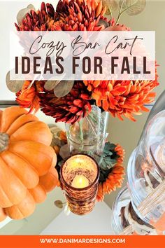 a vase filled with flowers and candles on top of a table next to an orange pumpkin