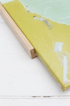 a close up of a piece of wood with paint on it and the edge of a board