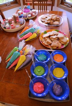 the table is full of colorful food and desserts