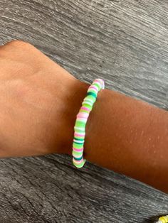 a person's arm with a bracelet on it