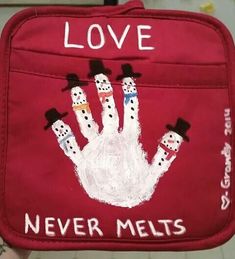 a red bag with snowmen painted on it and the words love never melts