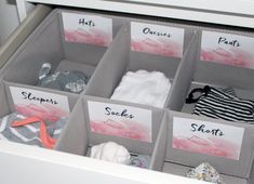 the drawers are organized with clothes and name tags to label them for each individual item