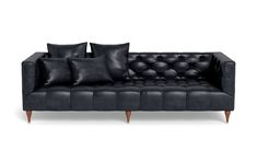 a black leather couch with four pillows on the armrests and three back cushions