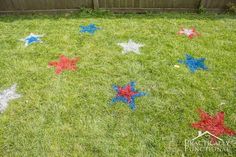 some red, white and blue stars in the grass