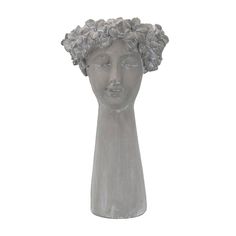 a gray ceramic busturine with flowers on it's head is shown against a white background