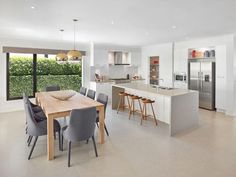 an open kitchen and dining room area with large sliding glass doors