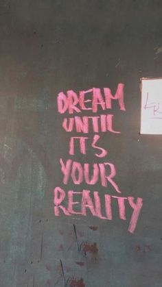 graffiti on the side of a building that says dream until it's your reality