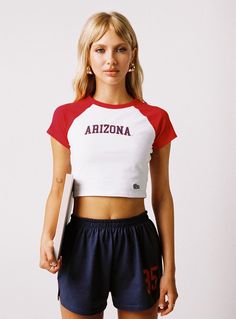 U of A Homerun Tee Red / White Sporty Stretch Cropped T-shirt With Graphic Print, Red Athleisure Tops With Letter Print, Sporty Cropped T-shirt With Graphic Print And Stretch, Sporty Stretch Crop Top With Graphic Print, Cotton Crop Top For College In Summer, Cotton Crop Top For Summer College Days, Summer Cotton Crop Top For College, Red Graphic Tee Cropped T-shirt, Red Sporty Crop Top For Streetwear