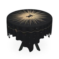 a round table with a black and gold star design on it's top, sitting in front of a white background