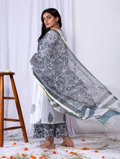 This suit set comes with a double dori neck detailing and a front long panel with borders. Pair it with a matching palazzo and handblock printed dupatta for a complete elegant look this summer. 100% Premium Cotton Printed Suit Set Chanderi Dupatta Comfort fit Set Contents: 1 Kurta, 1 Dupatta, 1 Palazzo Model height is 5.7 feet and is wearing size M Wash Care Instructions: Dry Clean Only Note: The product will be delivered within 15-20 days of the order placed. The product can be made on order, i Bohemian White Palazzo Set With Dupatta, White Chanderi Kurta With Block Print, White Cotton Sharara With Sheer Dupatta, White Chanderi Block Print Set, Unstitched White Bohemian Palazzo Set, White Cotton Silk Kurta With Block Print, White Mulmul Sets With Sheer Dupatta, White Block Print Chanderi Set, Transitional Season Mulmul Palazzo Set With Cutdana